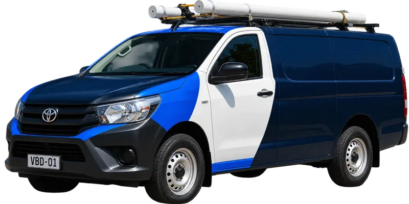 A licensed Baulkham Hills plumbing van loaded with pipe on the roof rack